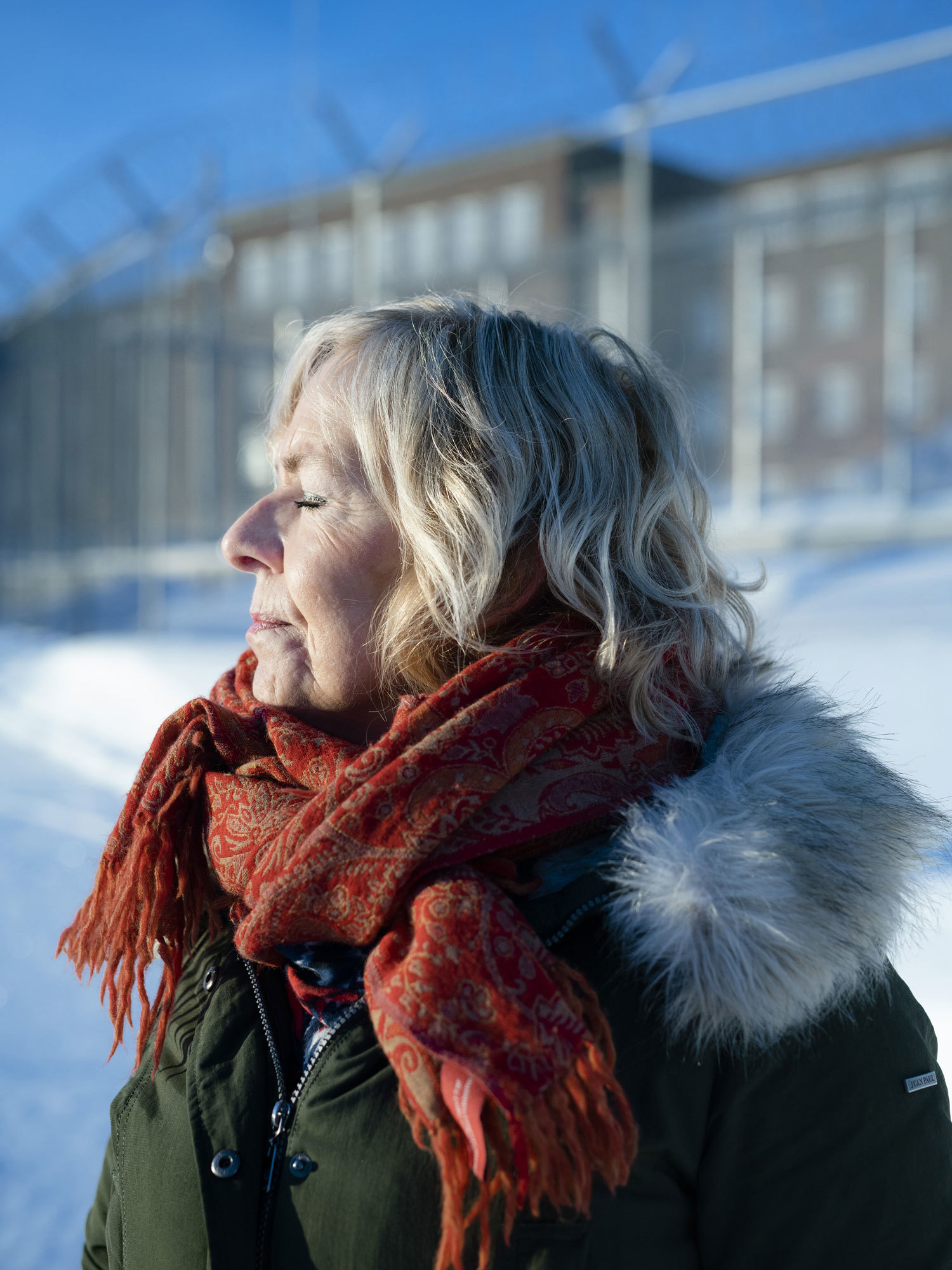 Portrait of Bente Almås in profile, in front of Ila Prison.