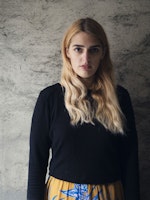 Larissa Terescenko står foran grå vegg og ser inn i kameraet