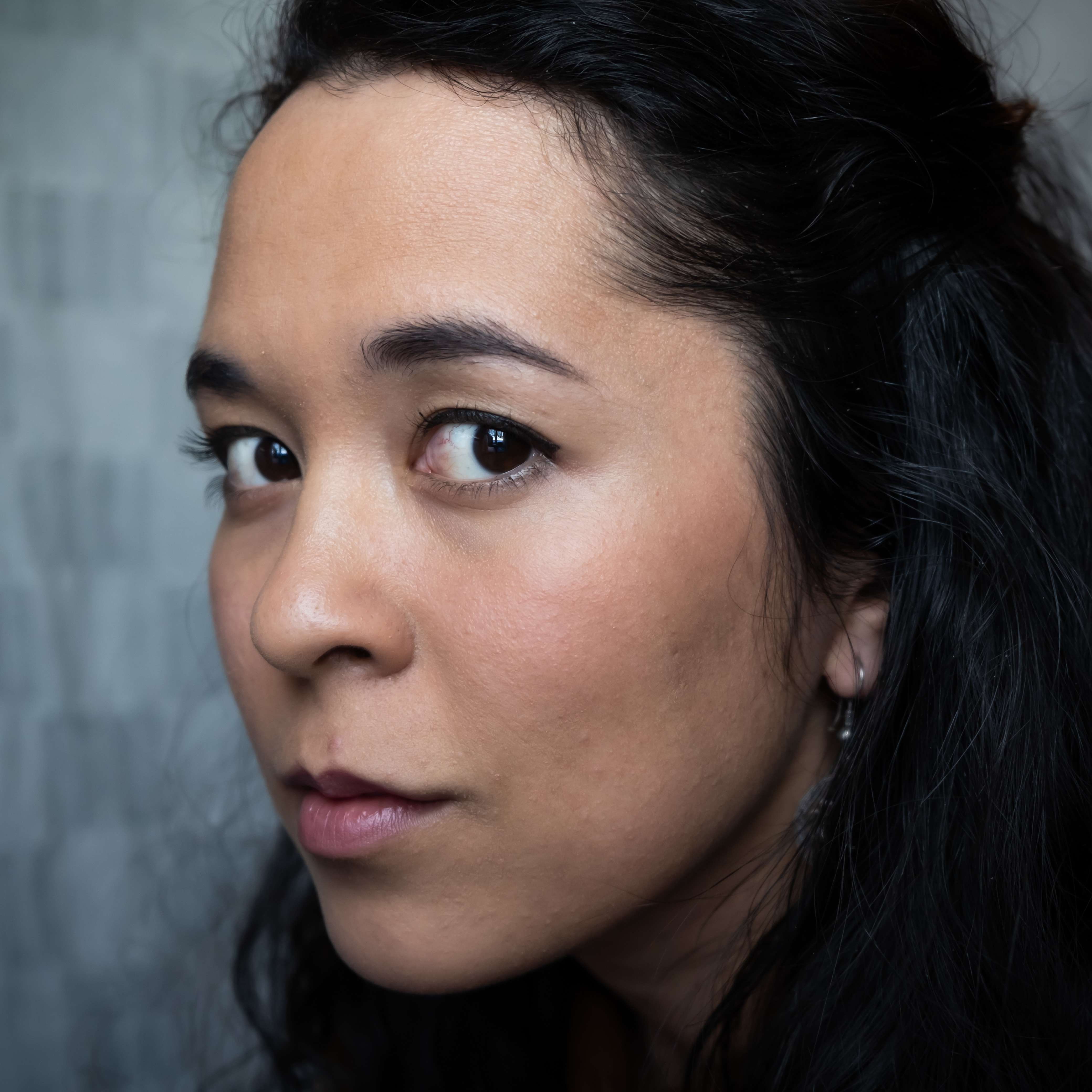 Zosha is looking into the camera.