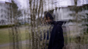 Tredimensjonalt fremstilt fotografi av Idin Samimi Mofakham går på en vei foran trær.