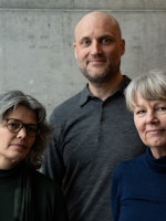 Rektorer på NMH, KHiO og AHO står ved grå betongvegg: Astrid Kvalbein, Markus Degerman og Irene Alma Lønne.
