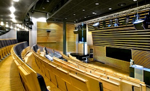 Et tomt auditorium med stolrader og podium.