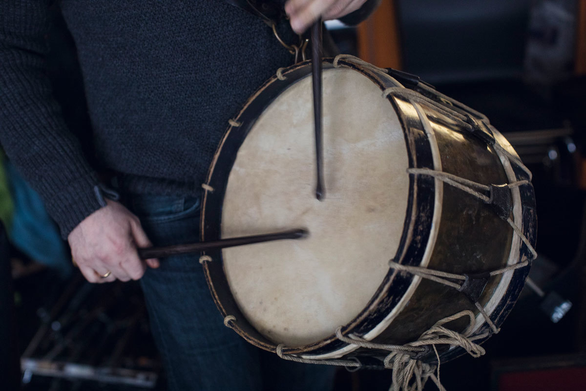 Hender spiller på slåttetromme.