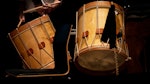 Two wooden drums. Dark background.