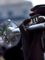 A close-up of a trumpet being played on.