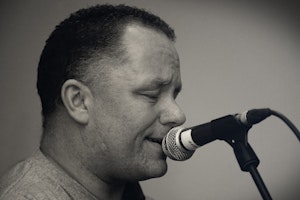 A man is singing into a microphone.