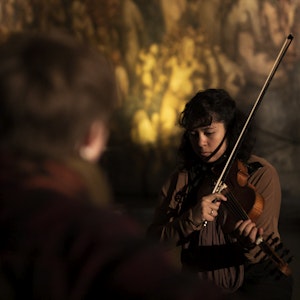 Student spille fiolin foran et lite publikum i Vigelands mausoleum.